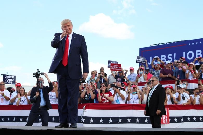 U.S. President Donald Trump gestures in front of supporters at Basler Flight Service in Oshkosh, Wisconsin. REUTERS/Tom Brenner    